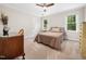 Comfortable bedroom with neutral carpet, a desk, and two windows for natural light at 103 Lochwood West Dr, Cary, NC 27518