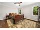 Bedroom with wood floors, ceiling fan, neutral walls, and a patterned area rug at 103 Lochwood West Dr, Cary, NC 27518