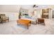 Bonus room featuring a comfortable sofa, a built-in bar, and ample natural light at 103 Lochwood West Dr, Cary, NC 27518