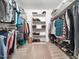 Walk-in closet with custom shelving and hanging racks for optimal storage space at 103 Lochwood West Dr, Cary, NC 27518