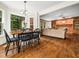 Dining area with chairs and a window with backyard views adjacent to living room area at 103 Lochwood West Dr, Cary, NC 27518