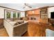 Cozy living room features brick fireplace with built-in shelving, hardwood floors, and natural light at 103 Lochwood West Dr, Cary, NC 27518