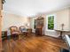 Bright living room with hardwood floors, vintage furniture, and plenty of natural light from large windows at 103 Lochwood West Dr, Cary, NC 27518