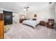 Spacious main bedroom with a ceiling fan, barn door, and neutral color scheme at 103 Lochwood West Dr, Cary, NC 27518