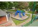 Bright and fun playground with slides, climbing structures, and a soft, safe ground cover at 103 Lochwood West Dr, Cary, NC 27518