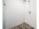Bathroom shower featuring white subway tile, updated fixtures, and a river rock shower base at 103 Lochwood West Dr, Cary, NC 27518