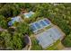 Aerial view of the community's four well-maintained tennis courts alongside lush green trees and a nearby pool at 103 Lochwood West Dr, Cary, NC 27518