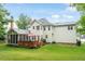 Expansive backyard featuring a deck, screened porch, and well-manicured lawn at 103 Rose Sky Ct, Cary, NC 27513