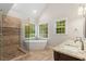 Bathroom featuring a soaking tub, glass shower, double sinks, granite counters, and tile flooring at 103 Rose Sky Ct, Cary, NC 27513