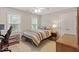 Bedroom with carpet floors, two windows with blinds, a ceiling fan, and a nightstand with a lamp at 103 Rose Sky Ct, Cary, NC 27513