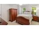 Bedroom featuring carpet floors, a bed, nightstand, wardrobe, and two windows with blinds at 103 Rose Sky Ct, Cary, NC 27513