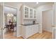 Dining area featuring hardwood floors and a glass cabinet, with a door leading to another room at 103 Rose Sky Ct, Cary, NC 27513