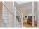 Bright foyer with white staircase, hardwood floors, and a view into the living room at 103 Rose Sky Ct, Cary, NC 27513