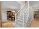 Elegant foyer with a staircase, hardwood floors, and a view of the dining room at 103 Rose Sky Ct, Cary, NC 27513