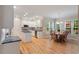 Bright kitchen boasts hardwood floors, a central island, and a breakfast nook with beautiful views of the backyard at 103 Rose Sky Ct, Cary, NC 27513