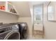 Well-equipped laundry room featuring front loading machines and a utility sink at 103 Rose Sky Ct, Cary, NC 27513