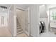 Laundry room with tile floor, washer and dryer, sink, and access to the carpeted staircase at 103 Rose Sky Ct, Cary, NC 27513