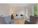 Cozy living room with hardwood floors, large windows, and comfortable seating at 103 Rose Sky Ct, Cary, NC 27513