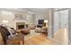 Inviting living room with fireplace, built-ins, hardwood floors, and ample seating at 103 Rose Sky Ct, Cary, NC 27513