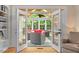 View from living room to sunroom with casual outdoor seating, bright light, and vaulted ceilings at 103 Rose Sky Ct, Cary, NC 27513