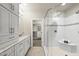 Beautiful bathroom featuring a glass shower, closet and white cabinets with granite countertops at 10529 Sablewood Dr # 111, Raleigh, NC 27617