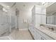 Clean, bright bathroom featuring double sinks, storage, a separate shower, and tile flooring at 10529 Sablewood Dr # 111, Raleigh, NC 27617