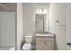 Neutral toned bathroom with a granite countertop and ample lighting above the sink and mirror at 10529 Sablewood Dr # 111, Raleigh, NC 27617