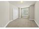 This bedroom features neutral walls and carpeting, closet, and a window with shutter style blinds at 10529 Sablewood Dr # 111, Raleigh, NC 27617