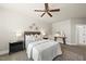 Inviting bedroom with neutral décor, ceiling fan, and ambient lighting, perfect for relaxation at 10529 Sablewood Dr # 111, Raleigh, NC 27617
