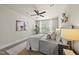 Cozy bedroom features a ceiling fan, neutral décor, and large windows offering plenty of natural light at 10529 Sablewood Dr # 111, Raleigh, NC 27617
