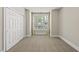 This bedroom features neutral walls and carpeting, closet, and a window with shutter style blinds at 10529 Sablewood Dr # 111, Raleigh, NC 27617