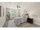 Comfortable bedroom features a ceiling fan, neutral décor, and large windows offering plenty of natural light at 10529 Sablewood Dr # 111, Raleigh, NC 27617