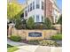 Well-manicured entrance to The Cottages with stone signage and lush landscaping offers a welcoming first impression at 10529 Sablewood Dr # 111, Raleigh, NC 27617