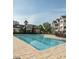 Community swimming pool showcasing sparkling blue water, deck and neighboring clubhouse against a clear blue sky at 10529 Sablewood Dr # 111, Raleigh, NC 27617