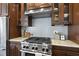This gourmet kitchen has a stainless steel range, tile backsplash, and custom wood cabinetry at 10529 Sablewood Dr # 111, Raleigh, NC 27617