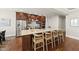 Modern kitchen with stainless steel appliances, granite countertops, and a large island at 10529 Sablewood Dr # 111, Raleigh, NC 27617