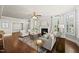 Open living room with hardwood floors, a fireplace, plantation shutters and natural light at 10529 Sablewood Dr # 111, Raleigh, NC 27617