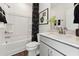 Clean bathroom featuring a shower-tub combo, a stylish vanity with a modern faucet, and neutral decor at 10538 Pleasant Branch Dr # 28, Raleigh, NC 27614
