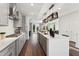 Bright, modern kitchen boasts gray cabinetry, stainless steel appliances, and a spacious island with pendant lighting at 10538 Pleasant Branch Dr # 28, Raleigh, NC 27614