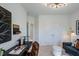 Home office showing lots of natural light, modern desk, and view of entry hall at 10538 Pleasant Branch Dr # 28, Raleigh, NC 27614