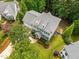 Aerial view of a two-story home with a well-manicured lawn and surrounding trees at 106 Fawley Ct, Cary, NC 27519