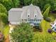 Aerial shot of a house showing its well-maintained roof, landscaping, and surrounding greenery at 106 Fawley Ct, Cary, NC 27519