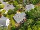 Aerial view of a well-maintained home with a deck and landscaped backyard surrounded by lush trees at 106 Fawley Ct, Cary, NC 27519