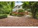 Backyard featuring a deck with outdoor seating, a lush garden, and a stone-paved pathway at 106 Fawley Ct, Cary, NC 27519