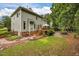 Backyard featuring a well-maintained lawn, stone and brick paths, and a home with a deck at 106 Fawley Ct, Cary, NC 27519