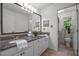Bathroom featuring granite countertops, white cabinetry, and a well-lit mirror at 106 Fawley Ct, Cary, NC 27519