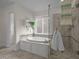 Bright bathroom with a soaking tub, shower, and stylish neutral tile and decor at 106 Fawley Ct, Cary, NC 27519