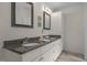 Bathroom featuring granite countertops, double sinks, and ample storage space in white cabinets at 106 Fawley Ct, Cary, NC 27519