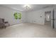 Spacious carpeted bedroom with natural light from a window and adjoining hallway at 106 Fawley Ct, Cary, NC 27519