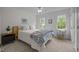 Bright bedroom featuring two large windows, plush carpet, and a cozy bed with a patterned comforter at 106 Fawley Ct, Cary, NC 27519